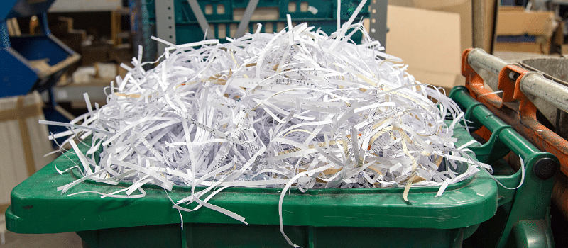 a secure shredding container filled with shredded paper.